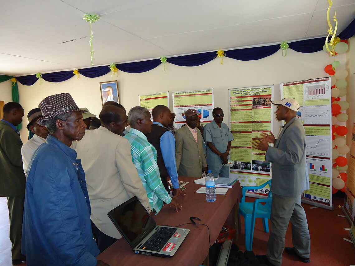 TTaCRI scientist giving technical advises to coffee growers during Nane nane Arusha